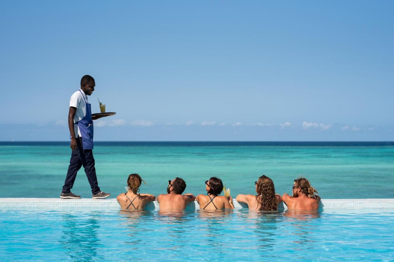 Hotel Nungwi Dreams By Mantis Esterno foto A butler serving drinks at Sandals Resorts